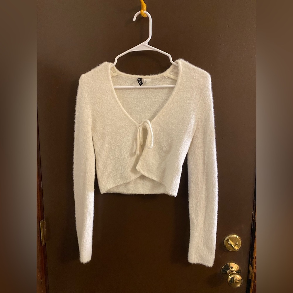 White Sweater top, ties in the front so best place on another shirt